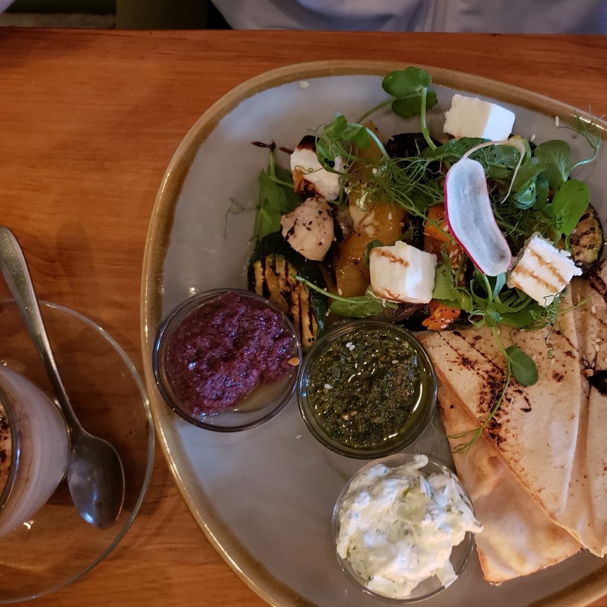 A vibrant meze platter with grilled vegetables, feta, dips and flatbread at a Brighton restaurant