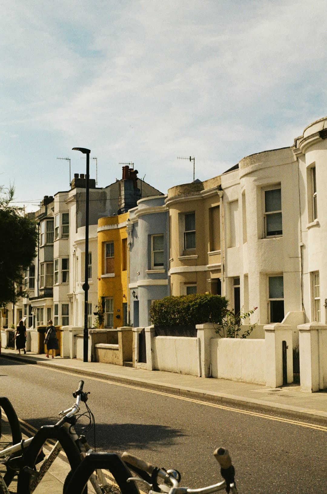 A yellow house standing out on a sunlit Brighton terrace