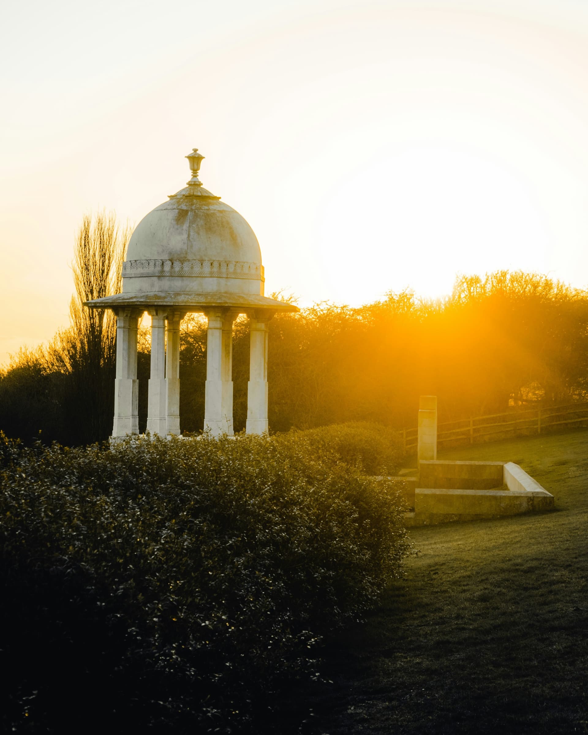 A domed memorial glowing at sunset near Chichester in West Sussex