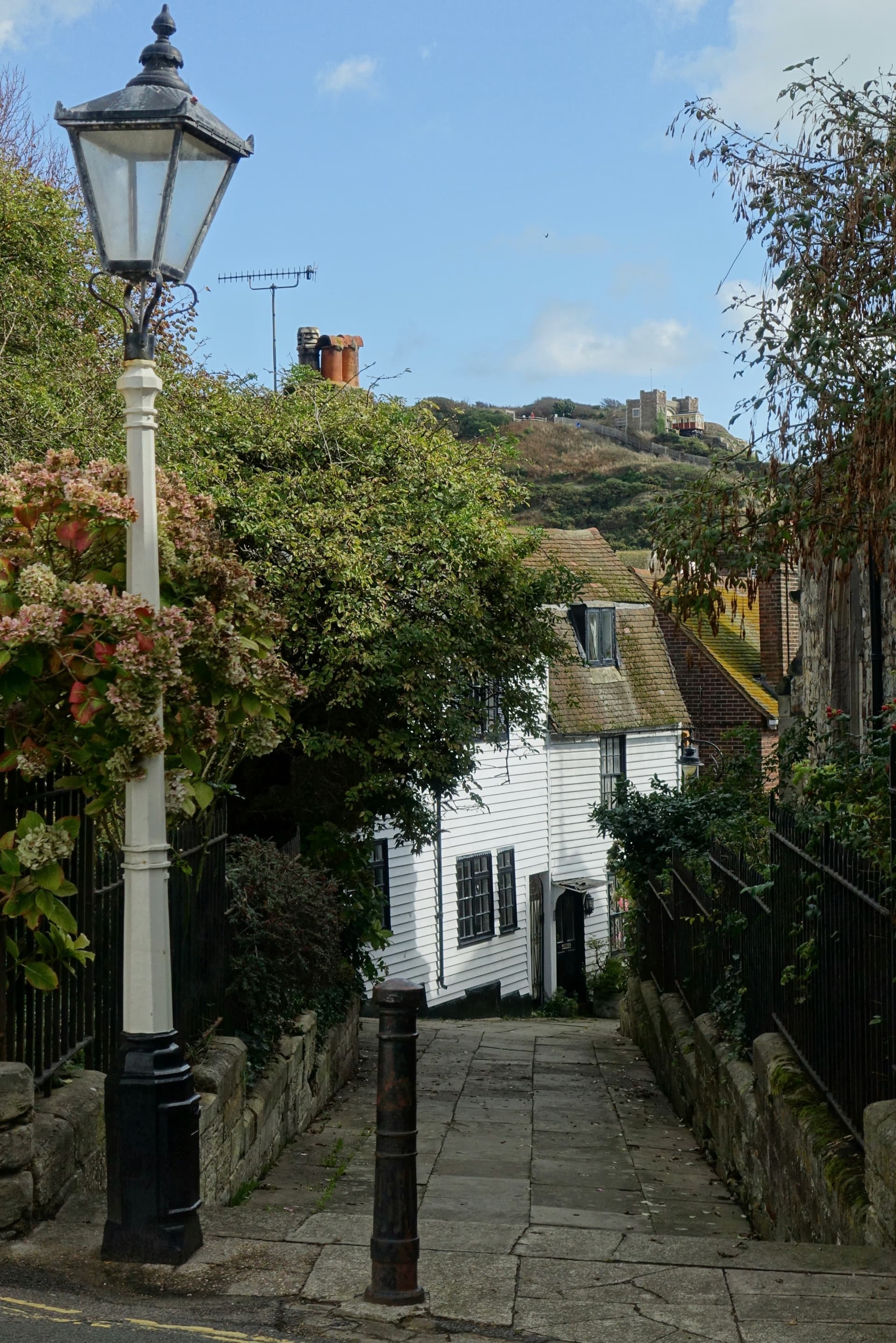 A white weatherboard cottage on a quiet coastal lane
