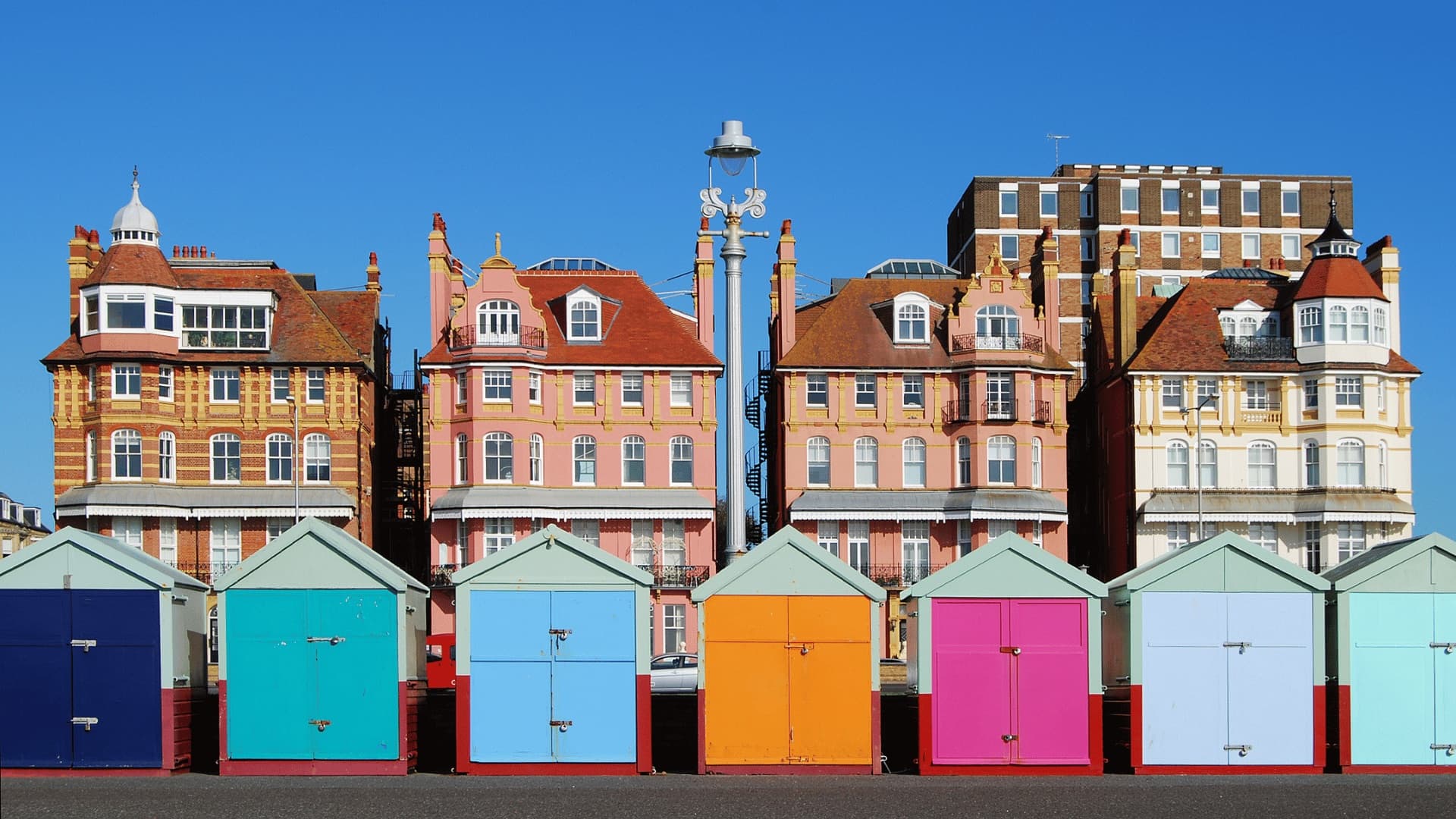 Colourful beach huts in front of Hove's ornate seafront architecture