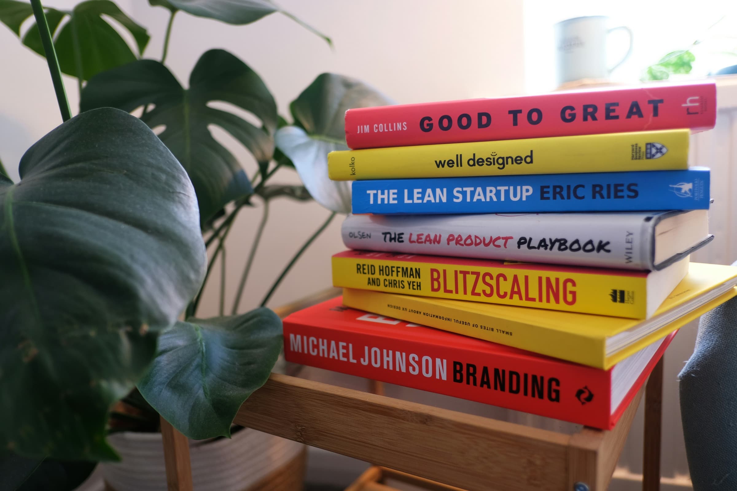 A stack of books about startups, product design and commercial growth
