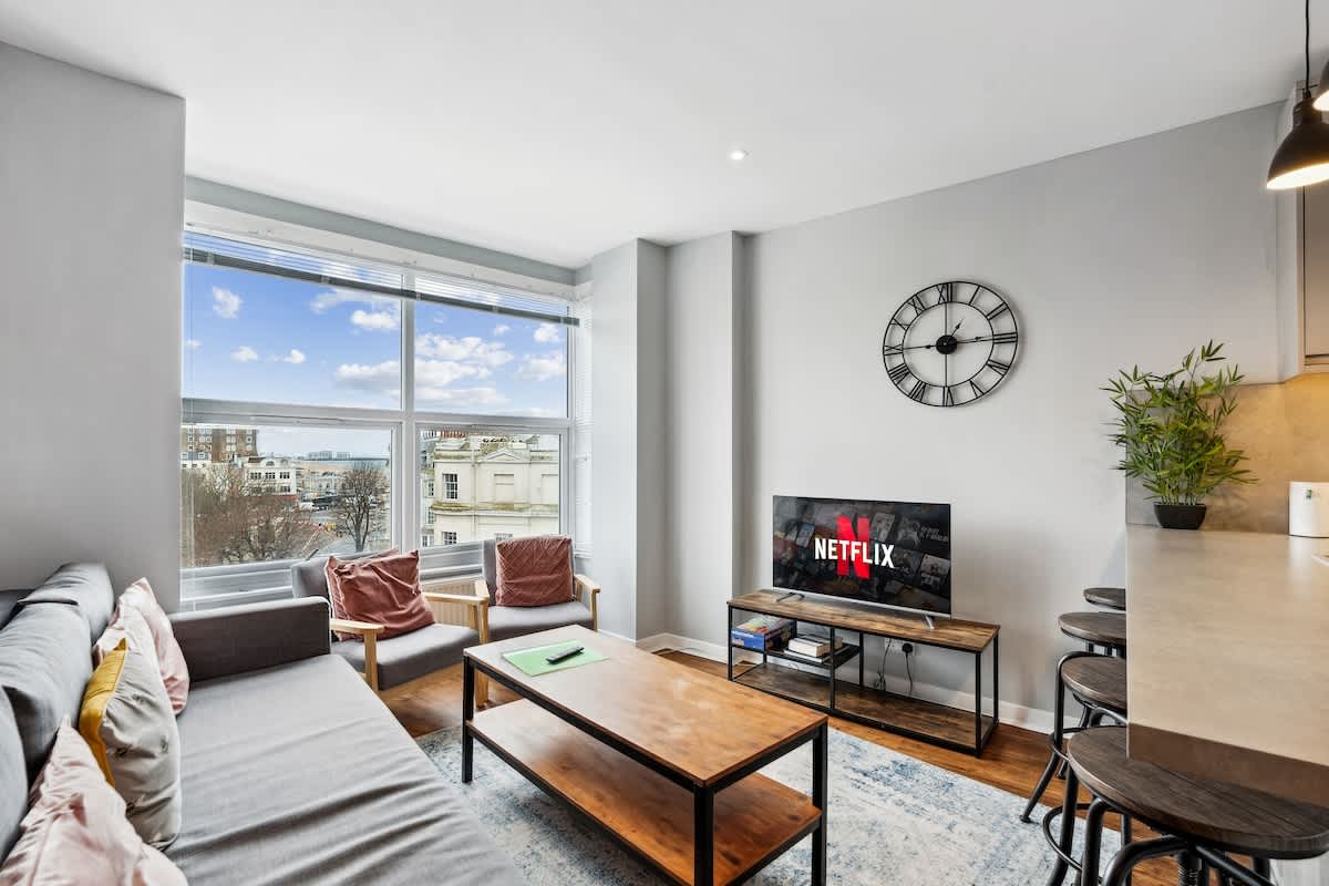 Living room of the Brighton group stay with views over the city towards the sea