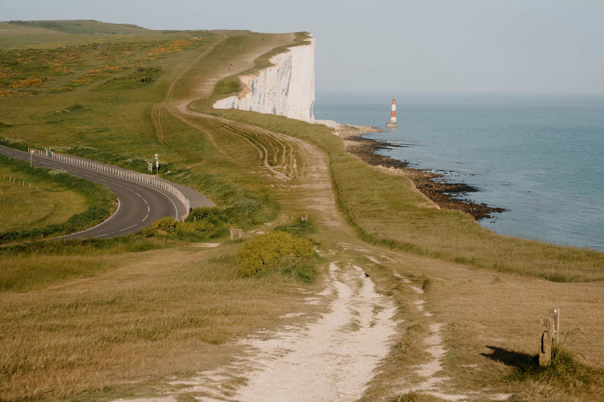 Clifftop path winding along the Seven Sisters towards the Beachy Head lighthouse