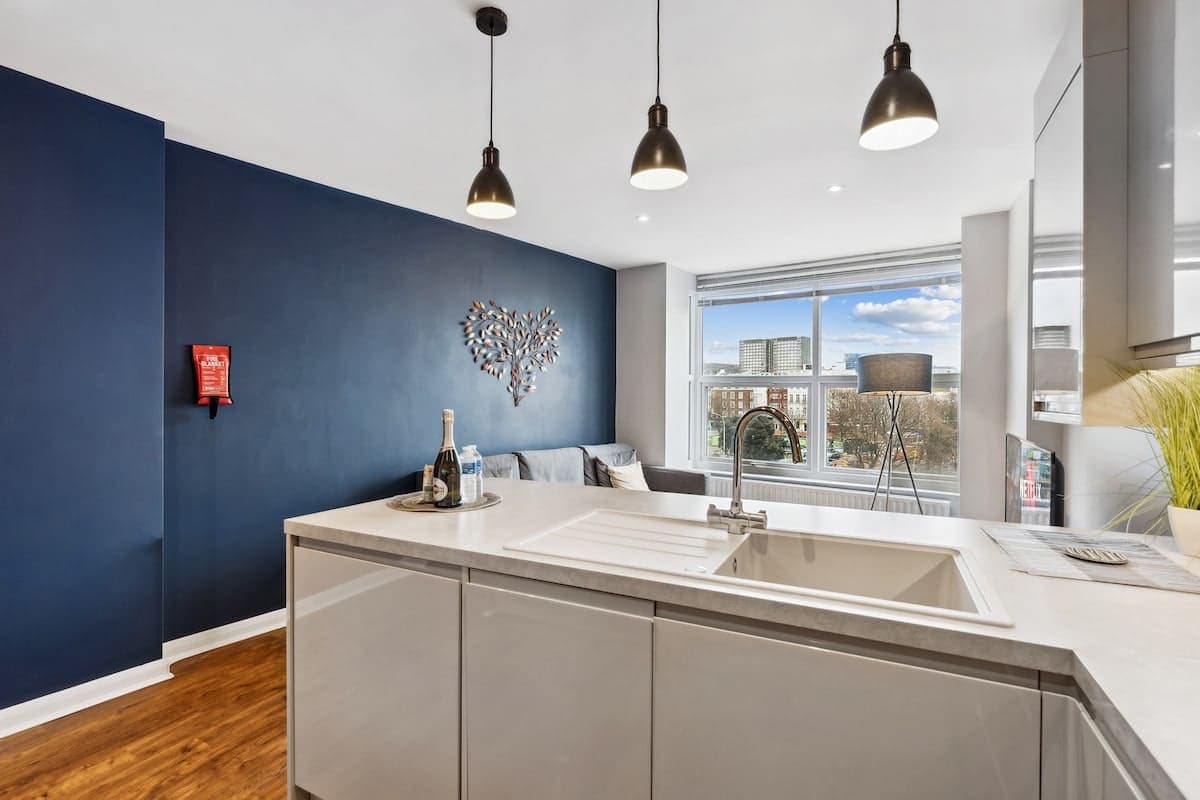 Navy-panelled kitchen island in a South House apartment near Brighton beach and the Lanes
