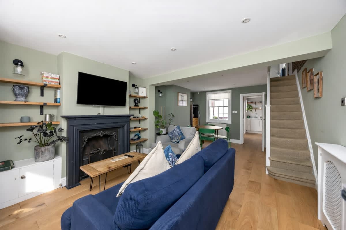 Cared-for living room in soft green tones at a South House-managed Brighton home